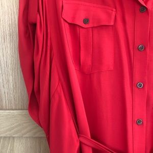 Vibrant red dress with cape-like feature along sides